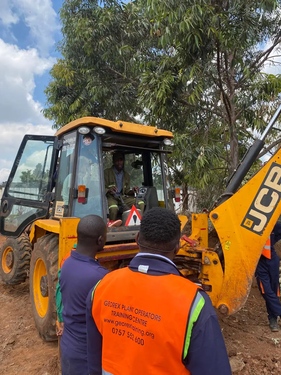 Georex students observing a live backhoe controls demonstration