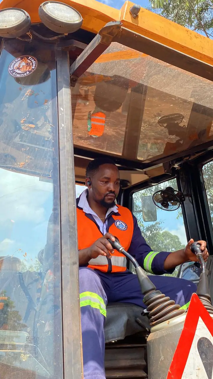 Georex instructor demonstrating backhoe control lever operation