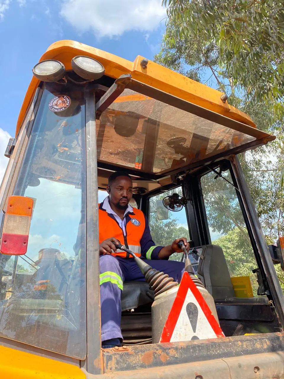Instructor demonstrating safe and precise backhoe controls from the cab