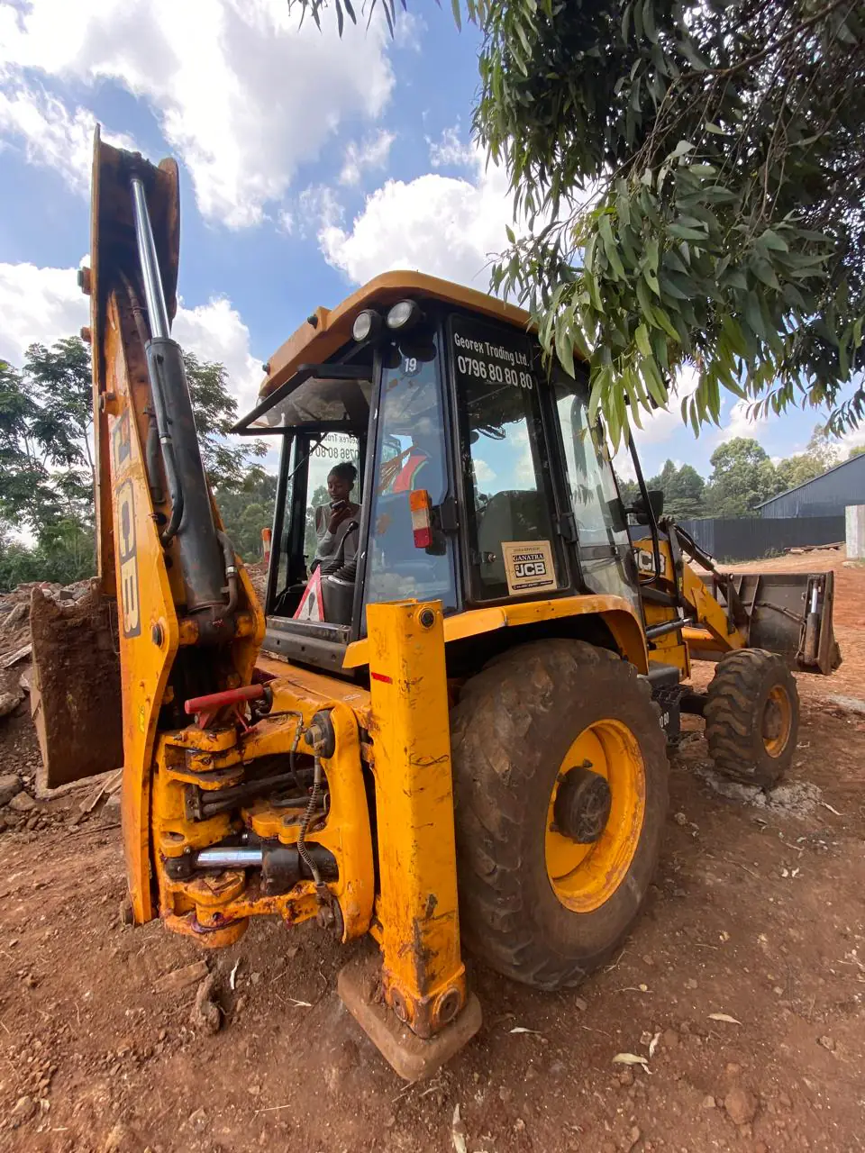 Georex student seated at the controls of a JCB backhoe loader